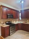 Kitchen featuring light countertops, range, a sink, and decorative backsplash