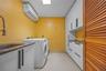A spacious laundry room adds further practicality to the home's thoughtful design.