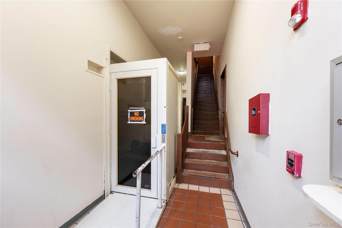 Stairway with tile patterned floors and baseboards