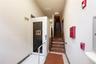 Stairway with tile patterned floors and baseboards