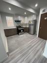 Kitchen featuring stainless steel appliances, light countertops, visible vents, a sink, and under cabinet range hood