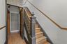 Stairway with a textured wall and wood finished floors