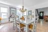 Dining space with a chandelier, ornamental molding, parquet flooring, and stairs