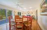 Dining space with baseboards, ceiling fan, a baseboard radiator, light wood-style flooring, and a fireplace