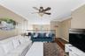 Recessed lighting, crown molding, ceiling fan, wood-finish flooring, and a second-story railing