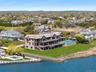 Aerial perspective of suburban area featuring a large body of water and a pool