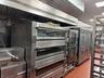 Kitchen featuring extractor fan, a warming drawer, and double oven