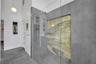 newer primary bath with unique marble details