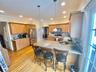 Kitchen featuring backsplash, kitchen peninsula, pendant lighting, and appliances with stainless steel finishes