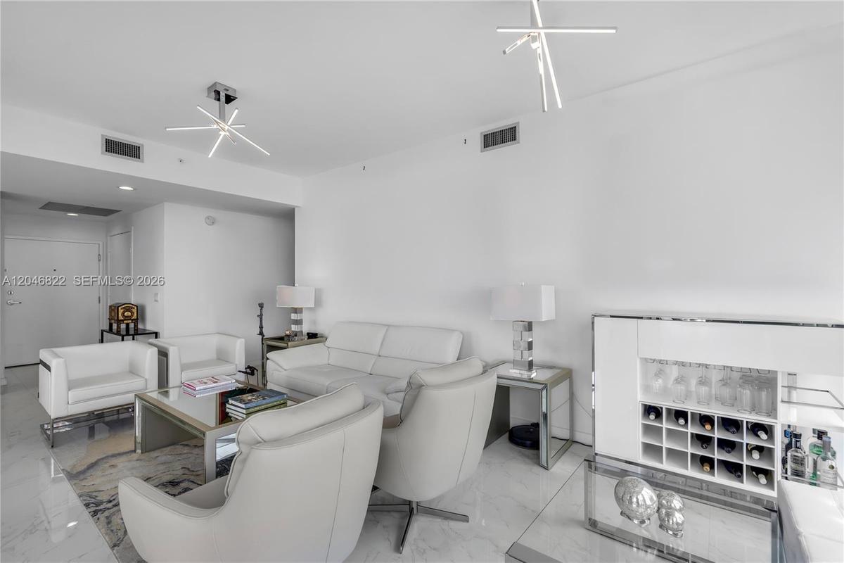 Furnished bedroom with floor-to-ceiling windows and bay views