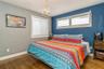 MASTER BEDROOM with inviting chandelier and dark hardwood / wood-style flooring