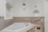 Full bath featuring a bath and crown molding