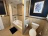 Bathroom featuring tile walls and shower / tub combo with curtain