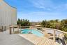 View of swimming pool featuring a deck and a pool with connected hot tub