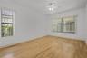 The spacious primary bedroom provides a peaceful retreat with room for a complete furniture arrangement.