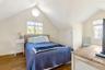 Bedroom featuring lofted ceiling, wood finished floors, and baseboards