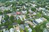 Aerial perspective of a residential street with mature trees and a variety of architectural styles