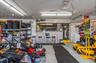 Garage with a workshop area, ceiling fan, and electric panel