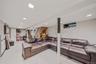 Living area featuring stairway, light tile patterned floors, and recessed lighting