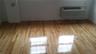 Detailed view of wood finished floors and a wall unit AC