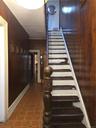 Staircase with wood walls and tile patterned floors
