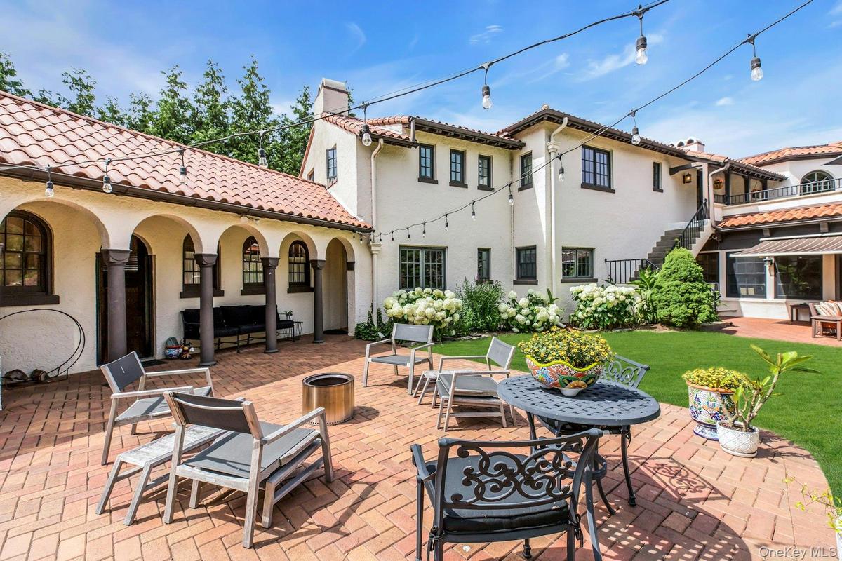 Private country club backyard featuring mature landscaping, fully fenced, brick patios, IGP & Spa, fountains