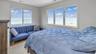 Bedroom featuring visible vents and a water view