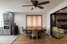 Wood-finish flooring, recessed lighting, ceiling fan light fixture, built-in stainless steel appliances, and brick fireplace
