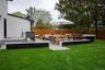 Fenced backyard with a deck and outdoor lounge area