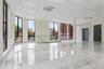 Spare room featuring floor to ceiling windows, a paneled ceiling, and marble tiled flooring