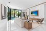 creating the perfect setting for relaxed living and effortless entertaining. Expansive glass doors fill the space with natural light and open to the o
