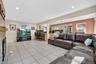 Living area with light tile patterned floors, a fireplace, and recessed lighting