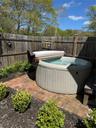 View of swimming pool with a hot tub and fence