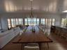 Dining room with a water view, an inviting chandelier, and wood finished floors