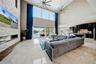Family room with floor to ceiling stone fireplace with porcelain tile floors