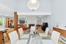 Dining area with light wood finished floors, a baseboard radiator, a fireplace, and recessed lighting