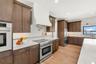 SHOWING ALL OF THE CABINET SPACE AND STORAGE CONVENIENTLY LOCATED IN THE KITCHEN