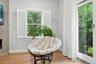 Delightful reading corner near patio sliders, custom plantation shutters