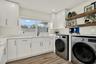 Indoor laundry room with utility sink
