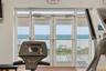 Beach Club fitness room with water views