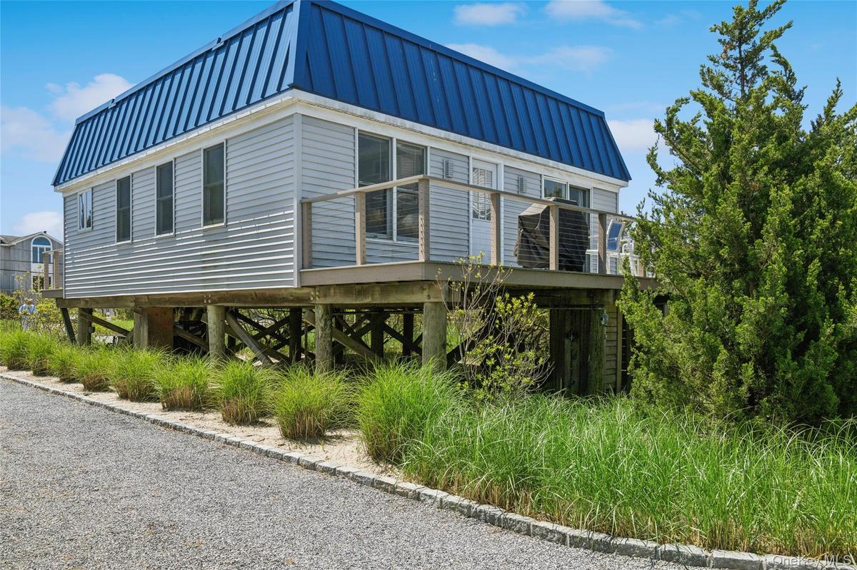 View of property exterior featuring metal roof and a standing seam roof