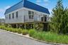 View of property exterior featuring metal roof and a standing seam roof