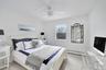 Bedroom featuring light wood-style floors, a ceiling fan, and a baseboard radiator