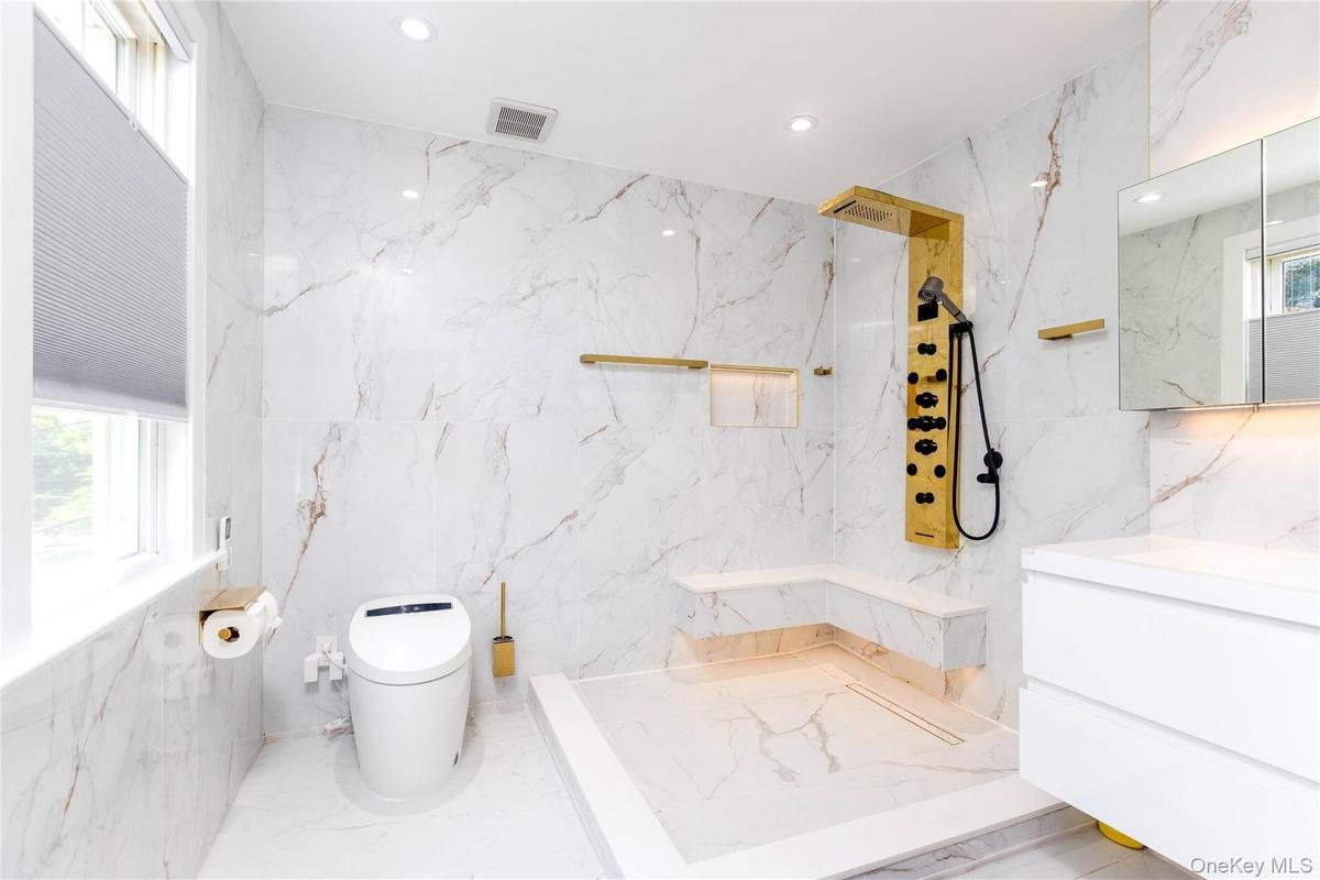 Ensuite Modern bathroom featuring large-format wall and floor tiling with subtle veining
