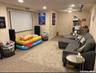 Carpeted cinema room with recessed lighting