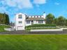 View of front of home featuring a garage, a front yard, driveway, and a chimney