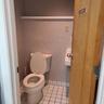 Bathroom with tile patterned floors, toilet, and baseboards