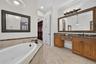 Primary Bathroom featuring dual vanities