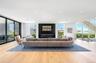Living area with floor to ceiling windows, wood finished floors, recessed lighting, and stairs