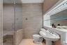 Pedestal sink with a polished chrome faucet, set against a full-width framed mirror with integrated lighting